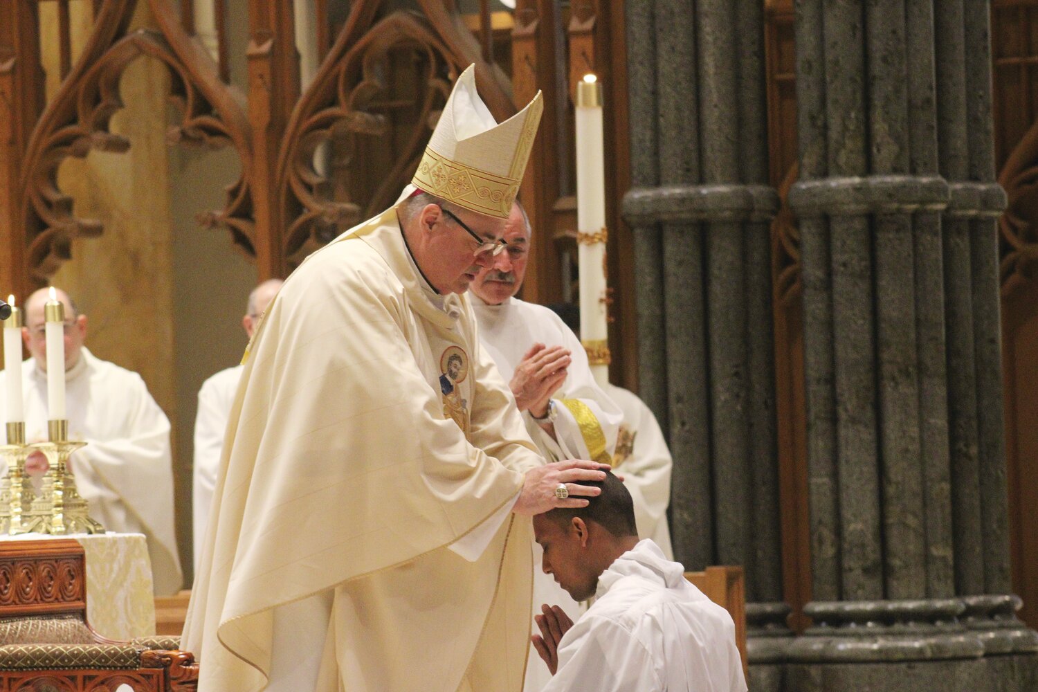 Bishop Richard G. Henning lays his hands upon the head of Providence Seminarian Jairon Olmos Rivera, ordaining him to the transitional diaconate on May 13 at the Cathedral of SS. Peter and Paul, Providence.